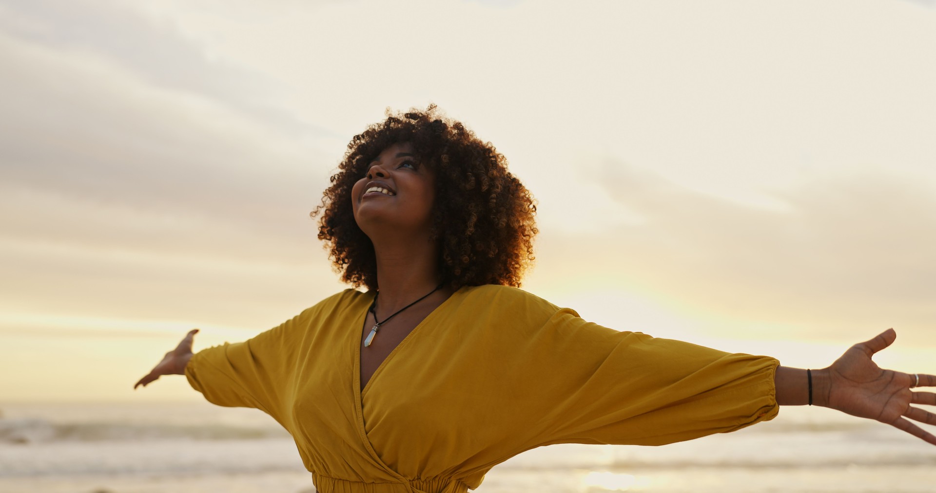 Sunrise, beach and happy woman for freedom, vacation and holiday weekend in Miami with smile. Ocean, mindfulness and carefree for adventure, peaceful and joy for sea breeze by scenic view outdoor