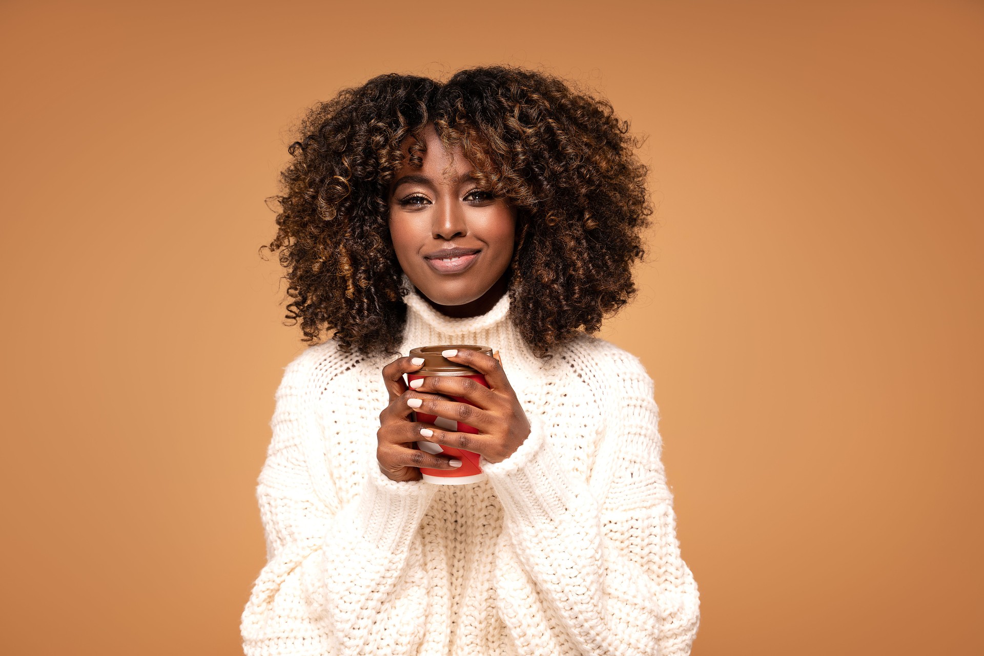 Happy afro girl with cup of coffee.