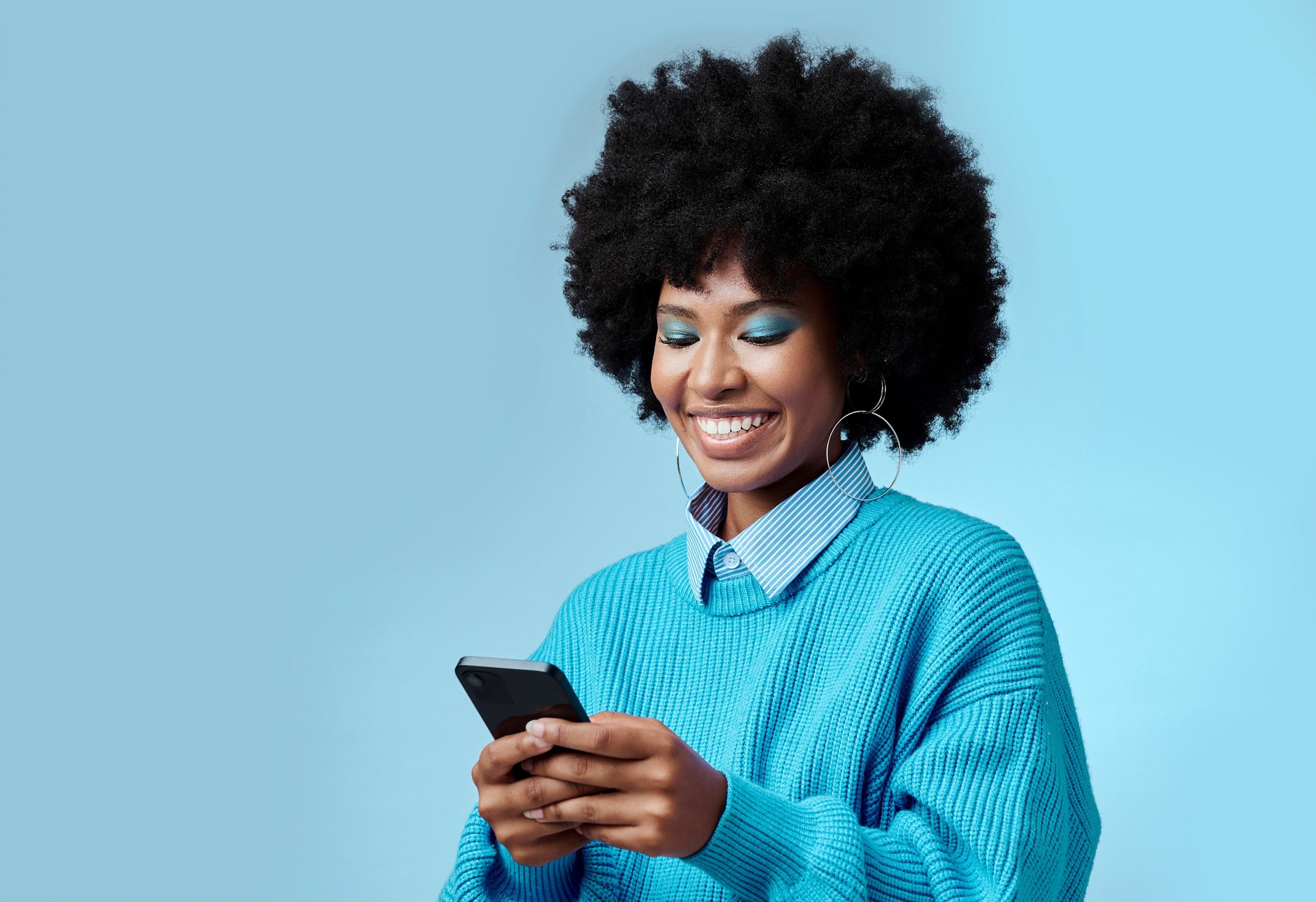 Mockup, smile and black woman with phone typing a online communication message to a contact using social media app. Retro, vintage and happy girl with afro hair doing a internet, web or online search